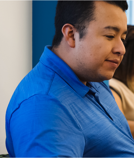 A young man looks intently at the work he is studying.